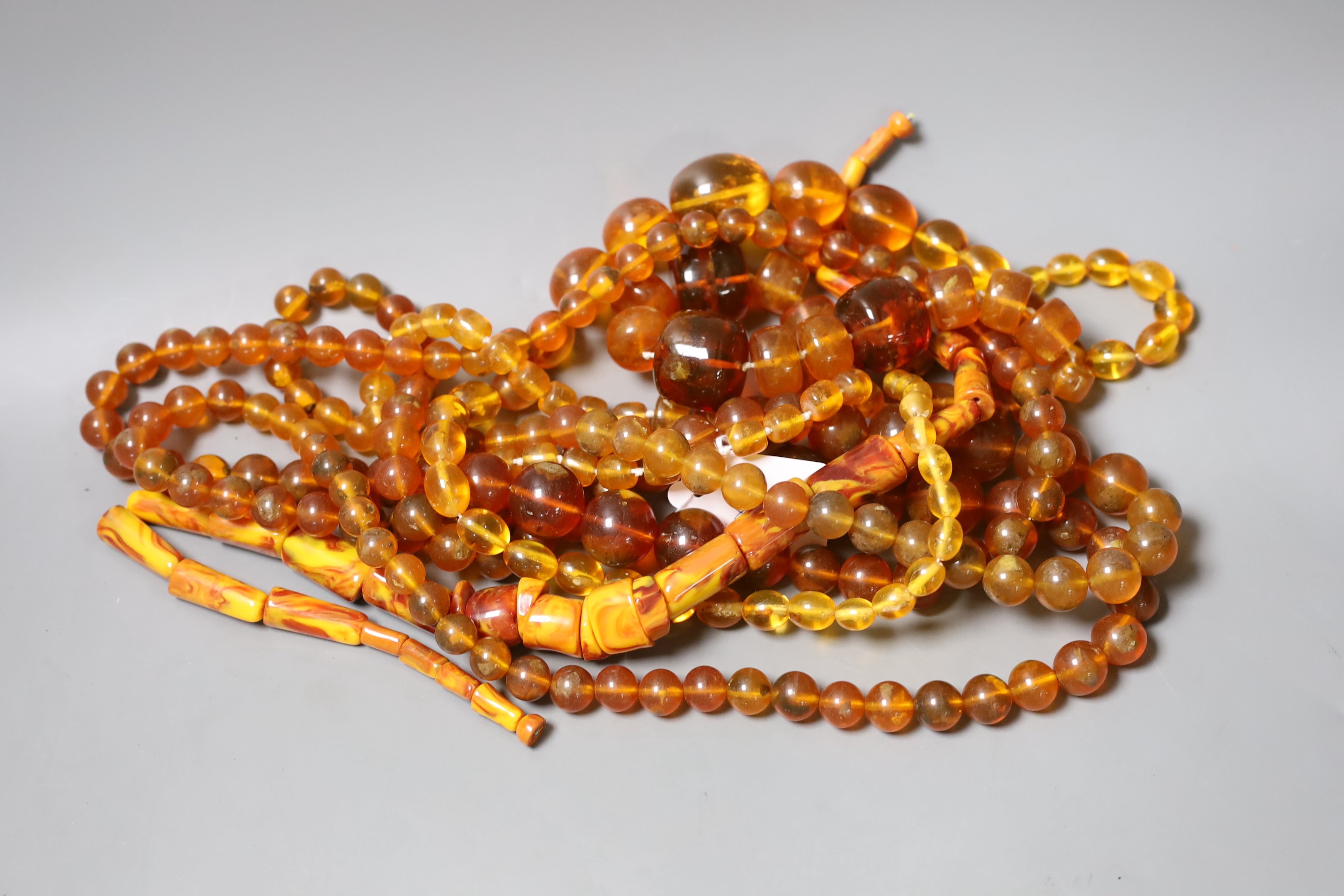 A group of amber and simulated amber bead necklaces (6).